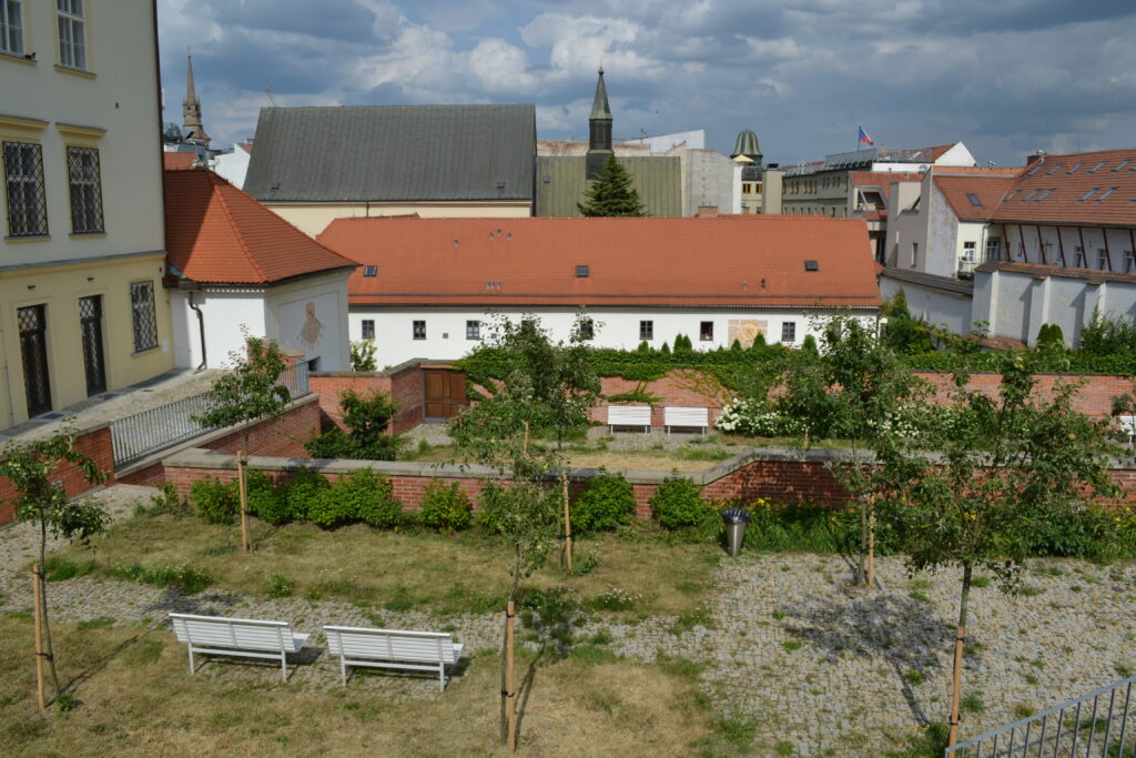 A small garden with benches sits in front an unassuming monastery in Brno. Wheely Tyred Brno hidden gems
