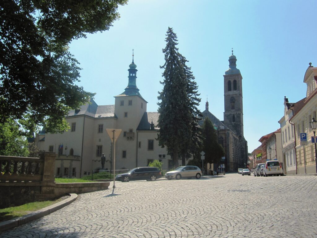 A large white building with a cobbled road leading up to it called the Vlašský dvůr or Italian Court. 