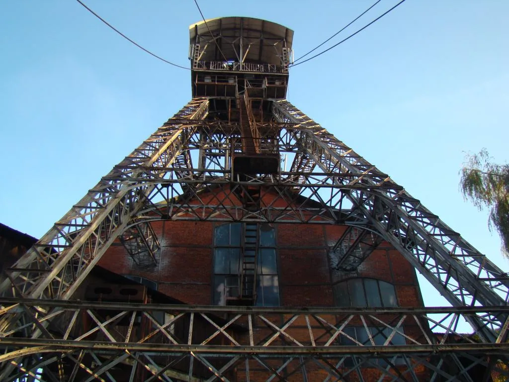 The crane of an old coal mine is shot from an angle underneath, making it look huge. It's Michal Coal Mine, Ostrava