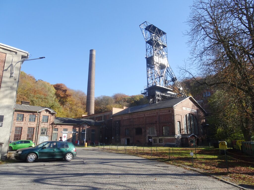 Cars park in front of the old mine at Landek Park, Ostrava