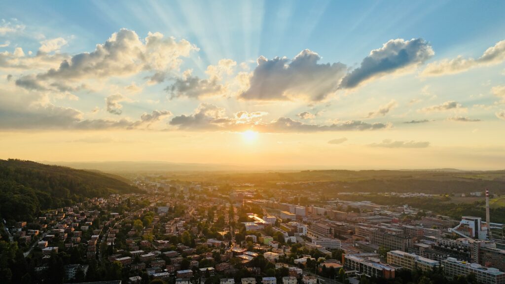 The sun sets over the functionalist city of Zlín, Czechia, in a wide aerial shot