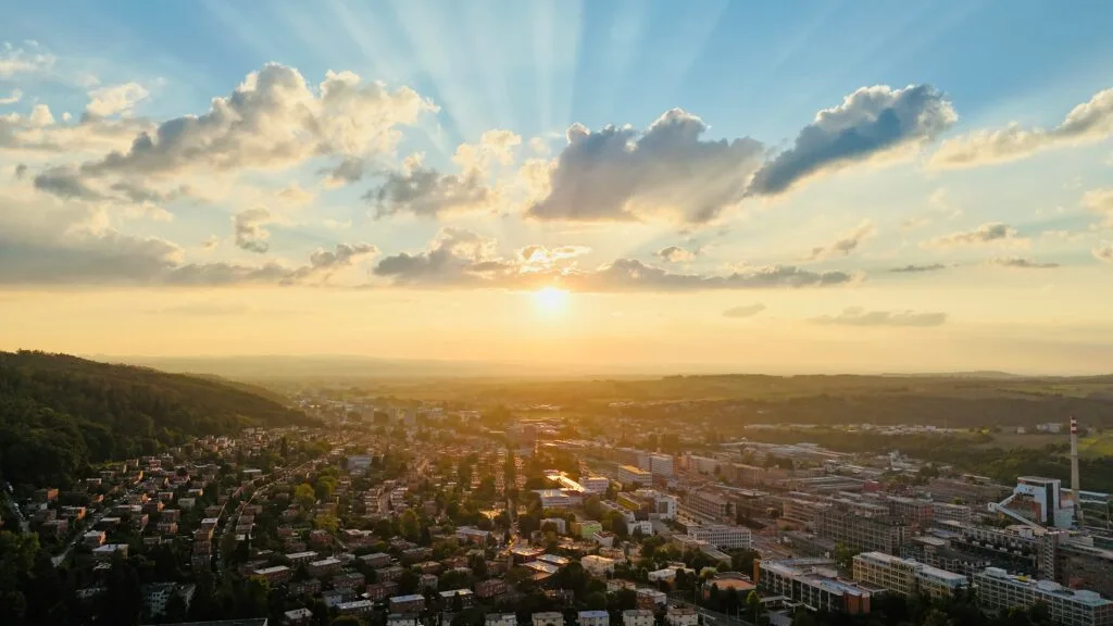 The sun sets over the functionalist city of Zlín, Czechia, in a wide aerial shot