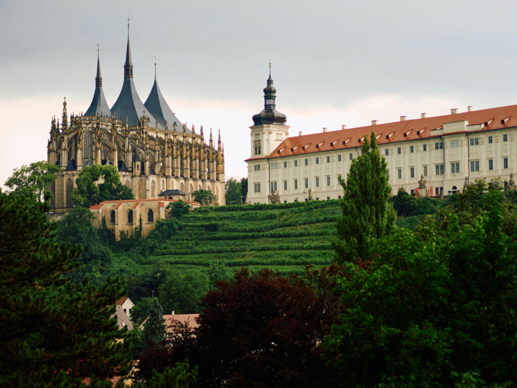 An ancient church and monastery sit on top of a green hill