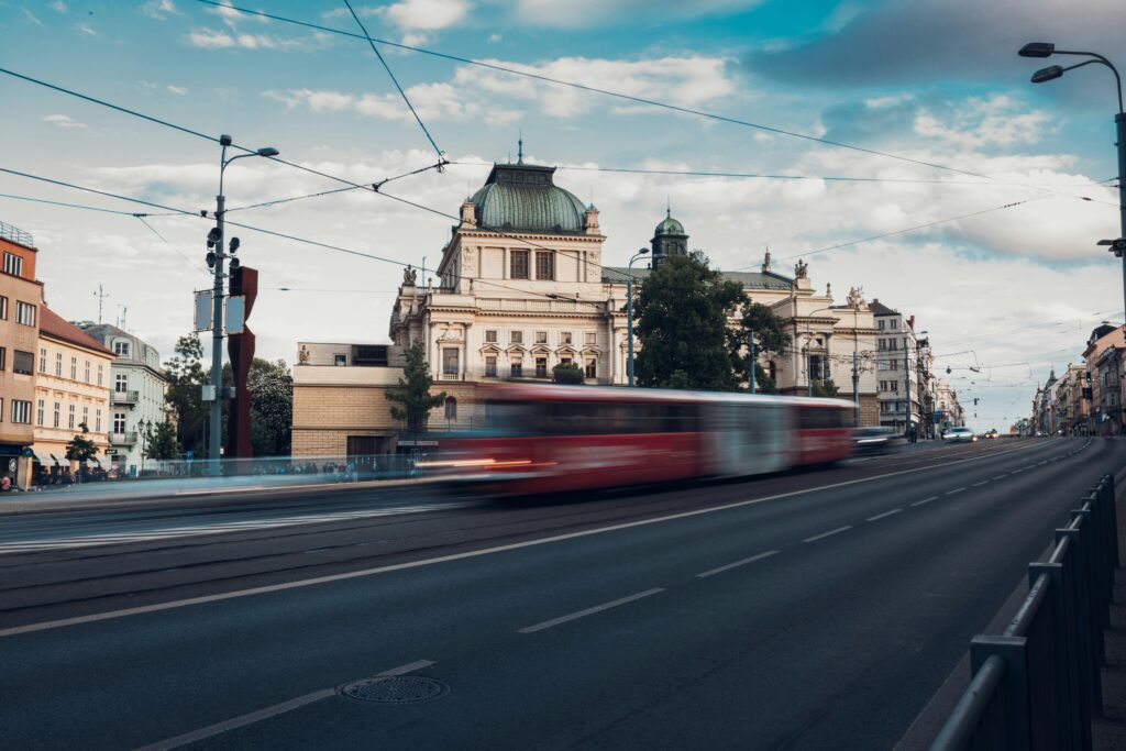 A tram rolls past some buildings in Plzen.