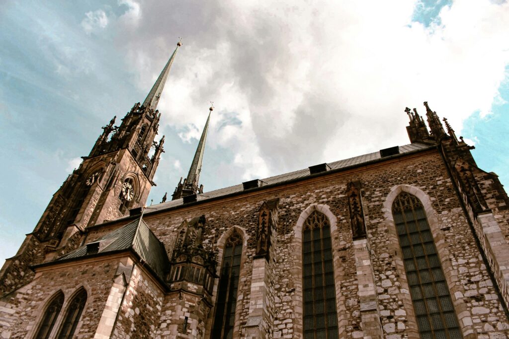 A twin-spired cathedral can be seen from below. It has huge glass windows built out of stone. Wheely Tyred Top attractions in Brno