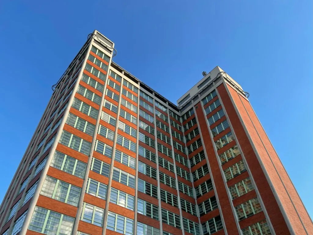 A skyscraper in Zlin caled Building No. 21 fills the picture. It is functionalist, with red brick work and large windows.