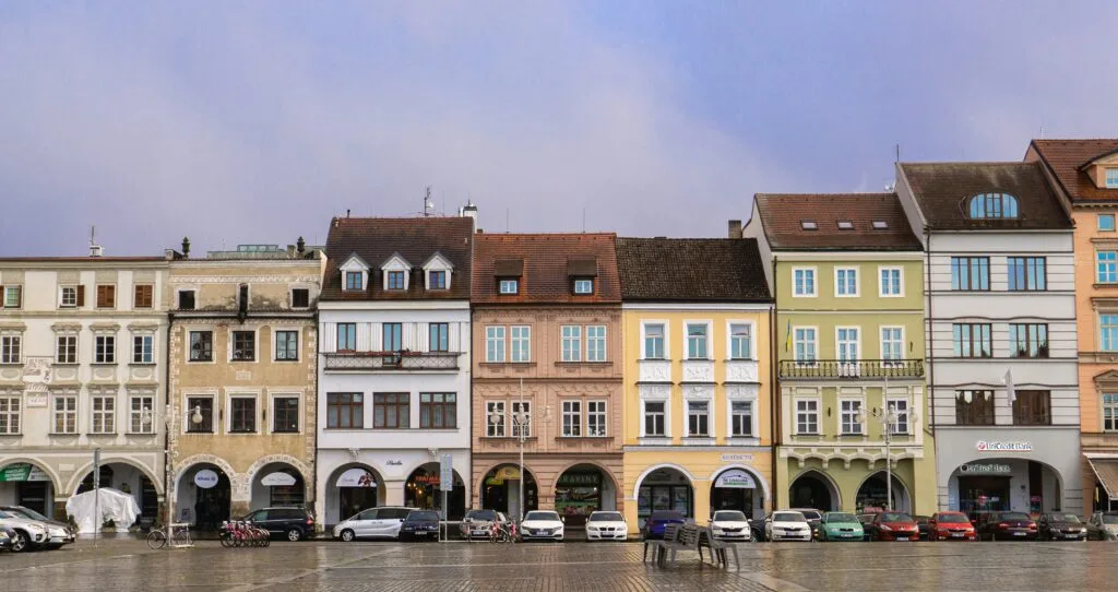 Houses line the main square of České Budějovice, Czechia, at dusk.