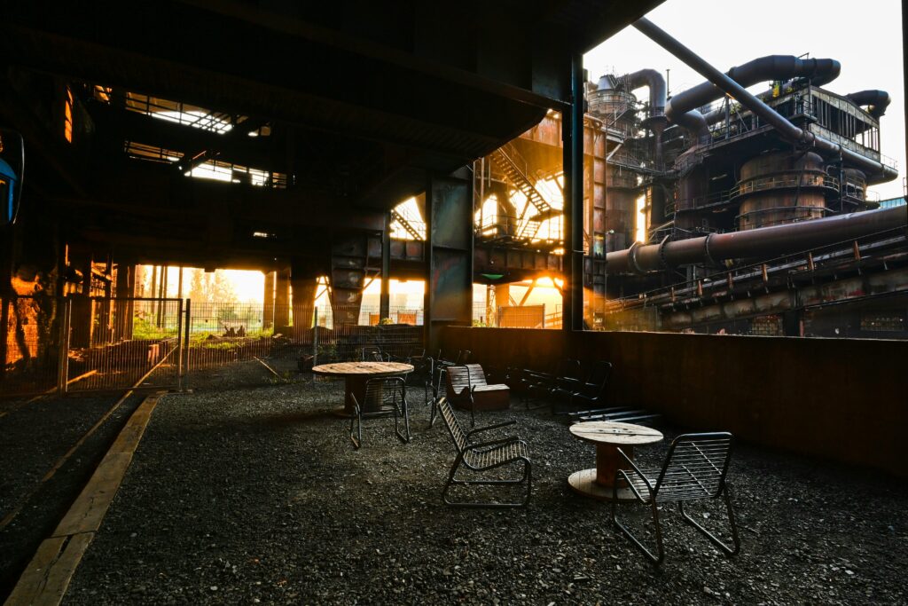 A table and chairs sit near one of the blast furnaces in Dolní Vítkovice
