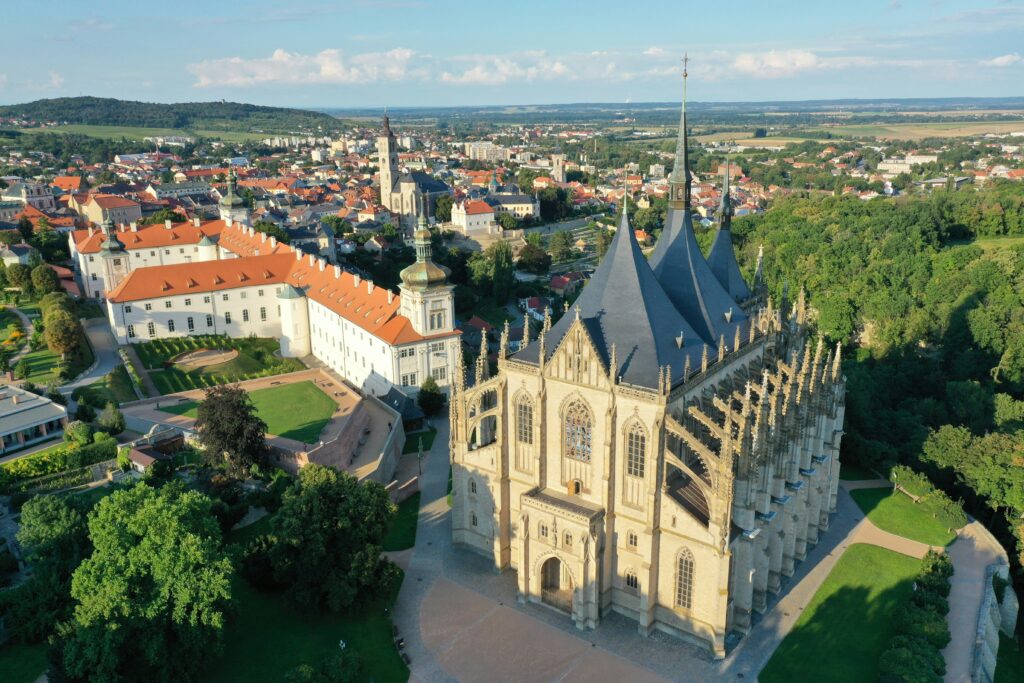An ancient church and monastery sit on top of a hill with the town stretching out behind