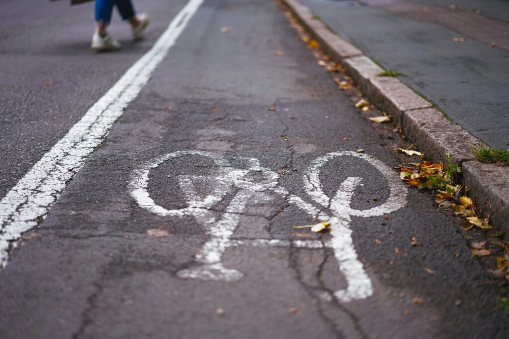 A poor-quality bike lane on a road. It's paint only, with no separation, and cracked. Wheely Tyred cycling laws Czechia