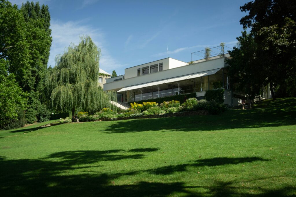 Villa Tugendhat, a white, modernist building, can be seen with steps leading down to a large green garden. Wheely Tyred Top attractions in Brno