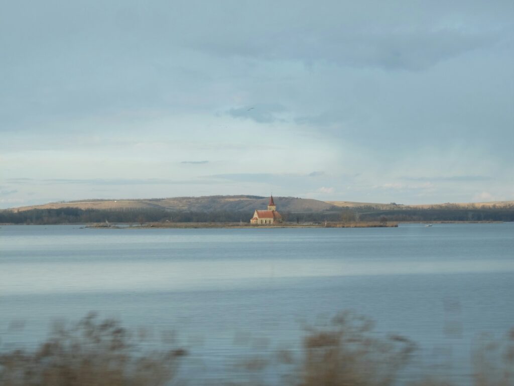 A church can be seen on an island in the middle of a lake near Mikulov