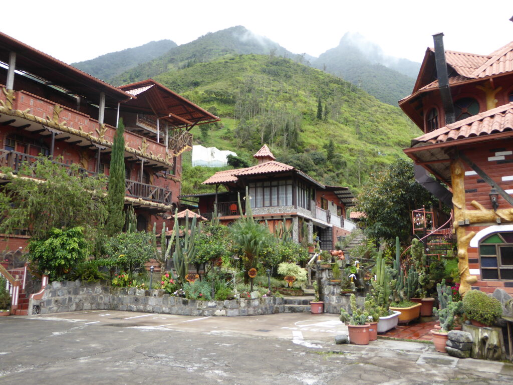 Hotels in Baños, Ecaudor, are dwarfed by huge green mountains.
