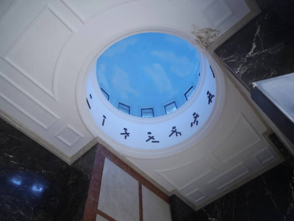 The blue sky shines through a white cupola in Cementerio General, Guayaquil, Ecuador.