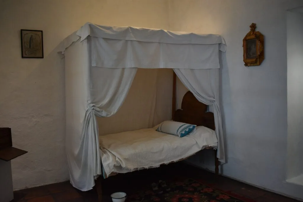 The bed of a nun in a display at Museo de las Conceptas in Cuenca, Ecuador. Wheely Tyred Hidden Gems in Cuenca