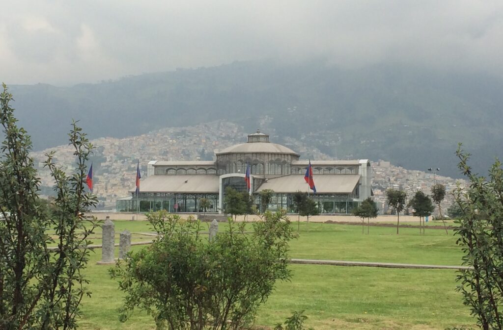 The Crystal Palace of Parque Itchimbia in Quito, with heavy clouds.