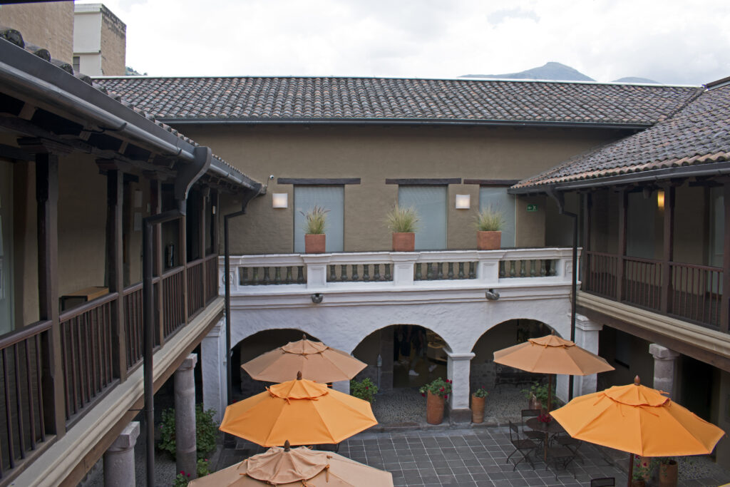 The courtyard of the Museo Casa del Alabado in Quito is full of orange umbrellas. Wheely Tyred Quito best hidden gems
