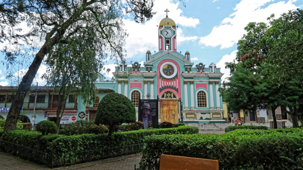 A pink and blue church in the main square of Vilcabamba, Ecuador