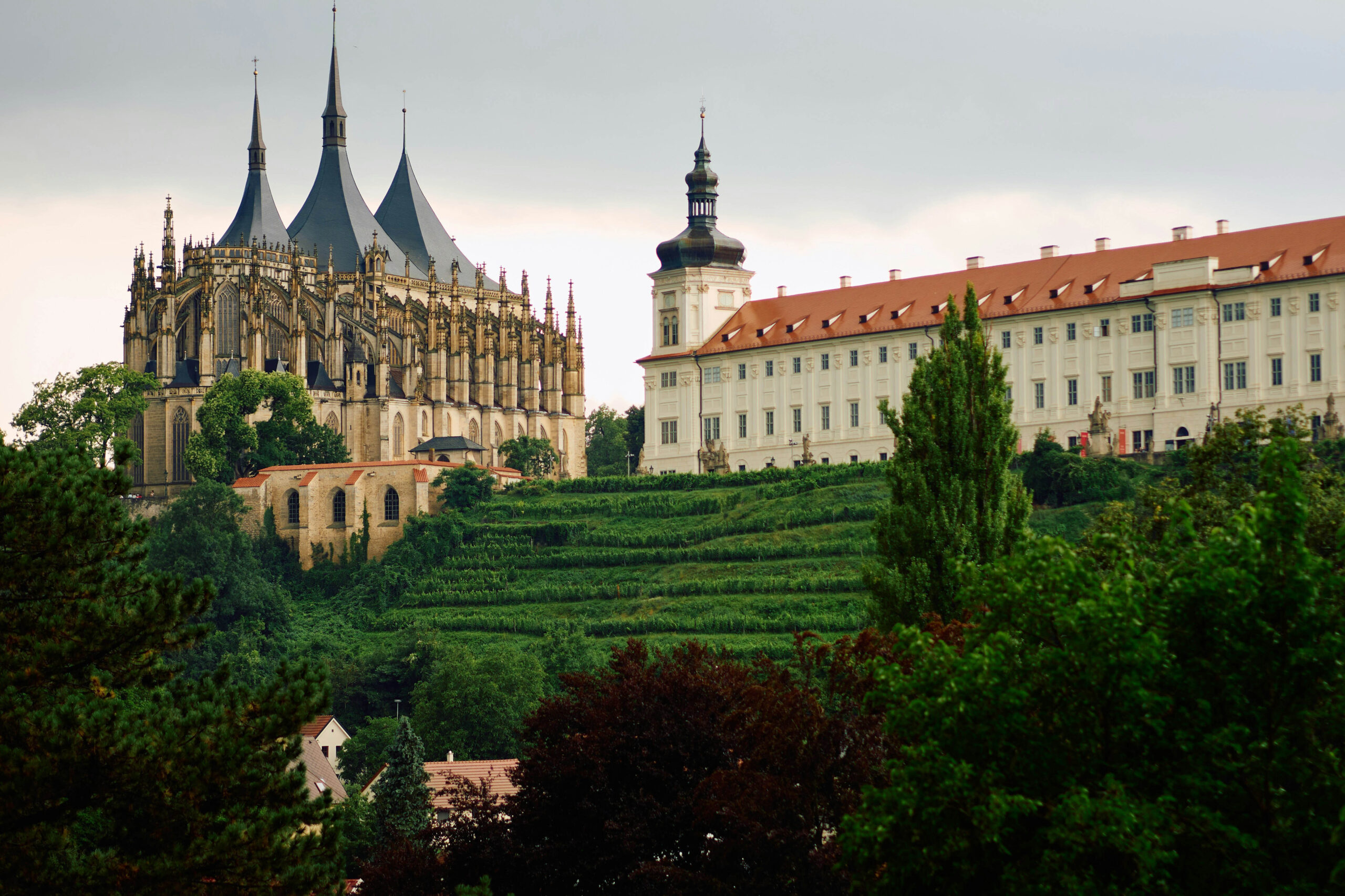 An ancient church and monastery sit on top of a green hill in Kutná Hora. Wheely Tyred Bohemia