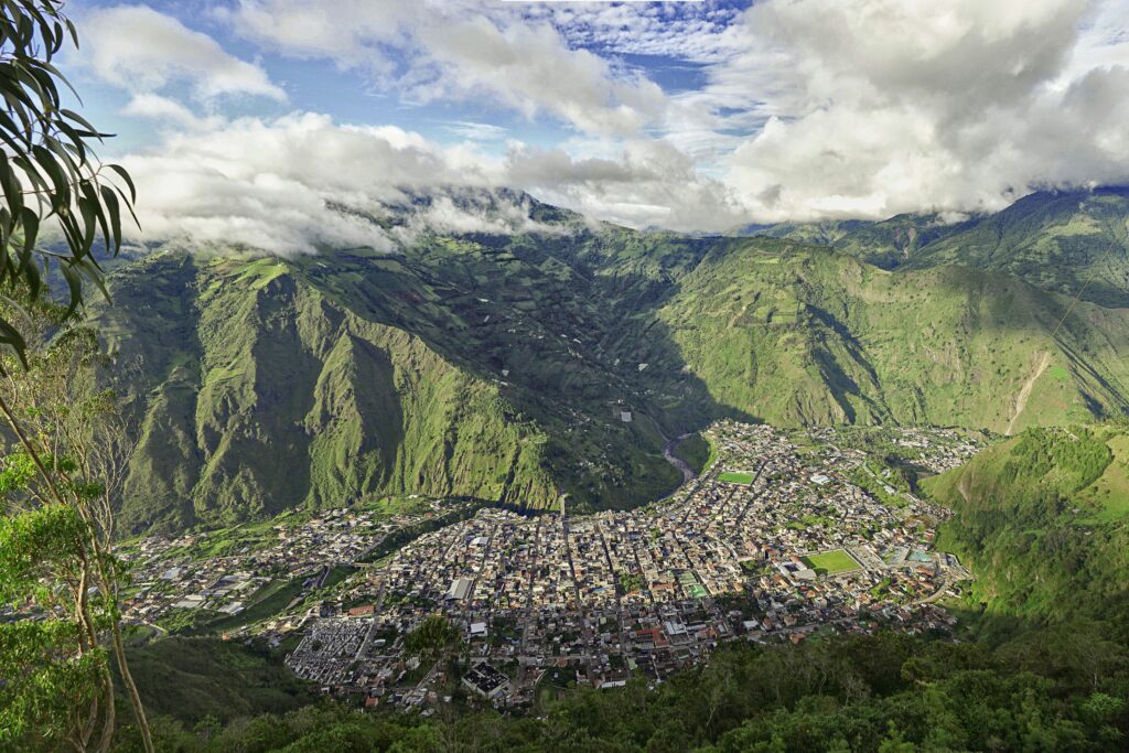 An aerial shot of the city of Baños, Ecuador, taken from the Casa del Arbol in the mountains above.