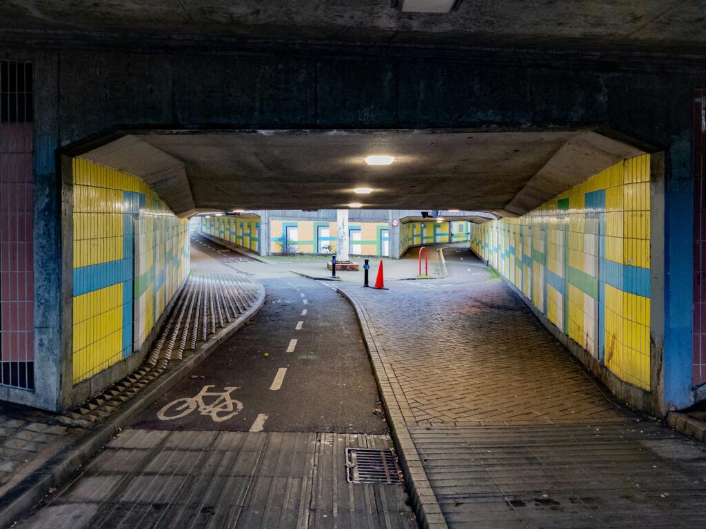 An urban bike lane runs through a multicoloured underpass in London