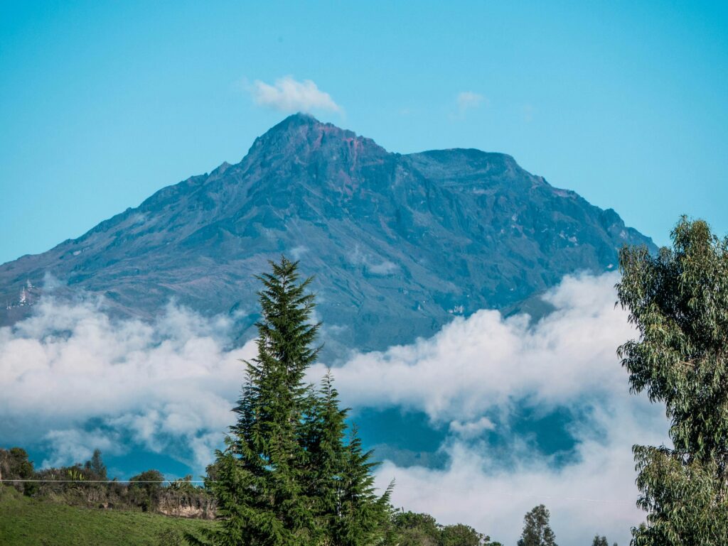 Cotocachi Volcano rises out of the clouds in Ecuador. Wheely Tyred Top sights in Ibarra