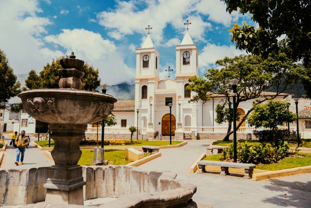 An old chuirch with a fountain in front of it in Quito, Ecuador.