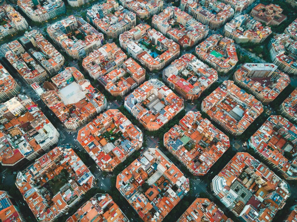 An aerial view of Barcelona's iconic grid and superblock road system in Eixample. Wheely Tyred barcelona beat traffic