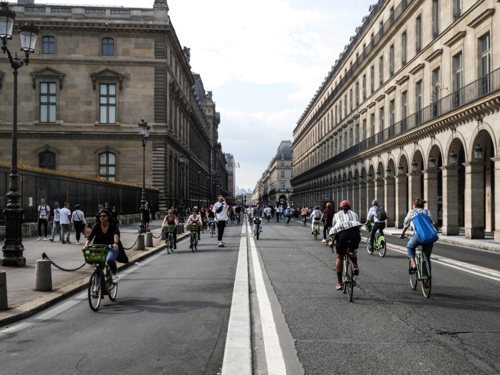 Hundreds of people cycle along bike lanes that take up the whole wideth of the road in Paris, France.