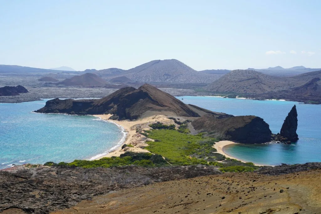 A peninsula of volcanic rock on the Galápagos Islands with Pinnacle Rock on display. Wheely Tyred best places to eat in the Galápagos