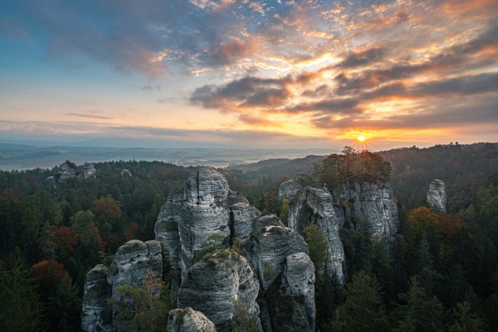 Huge rock formations poke through the top of a forest of pine trees in Bohemian Paradise near Turnov, Czechia. Wheely Tyred hidden gems in Czechia