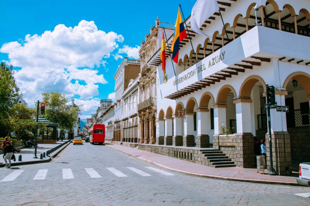 Buildings in Parque Calderon in Cuenca fly the flags of Ecuador and Azuay