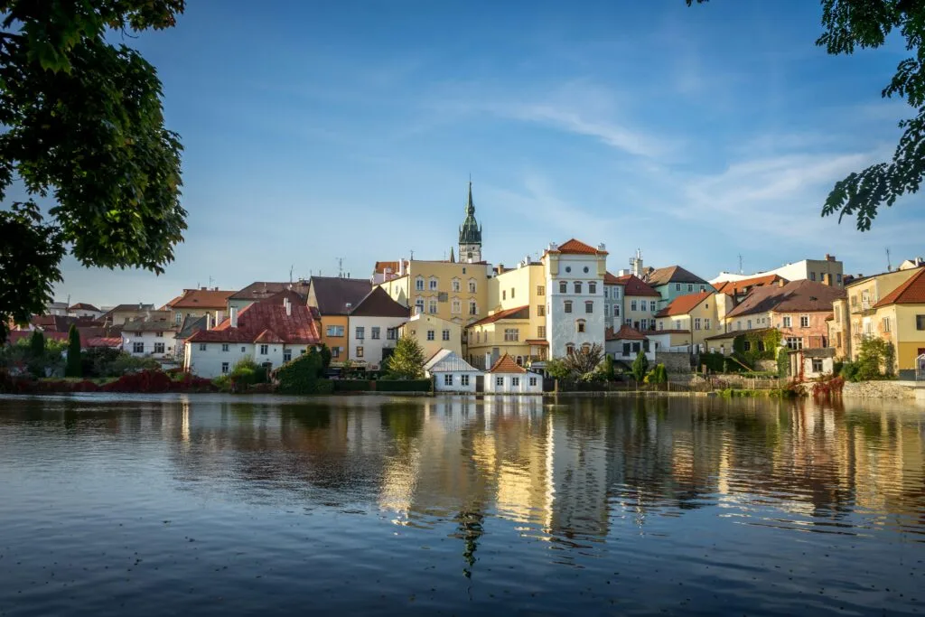 The town of Jindrichuv Hradec, Czechia, can be seen reflected in still water on a clear day.