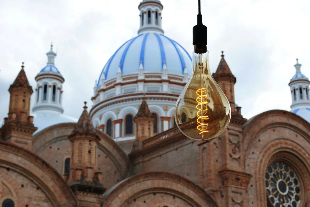 A lightbulb hangs in front of one the domes on the New Cathedral in Cuenca, Ecuador.