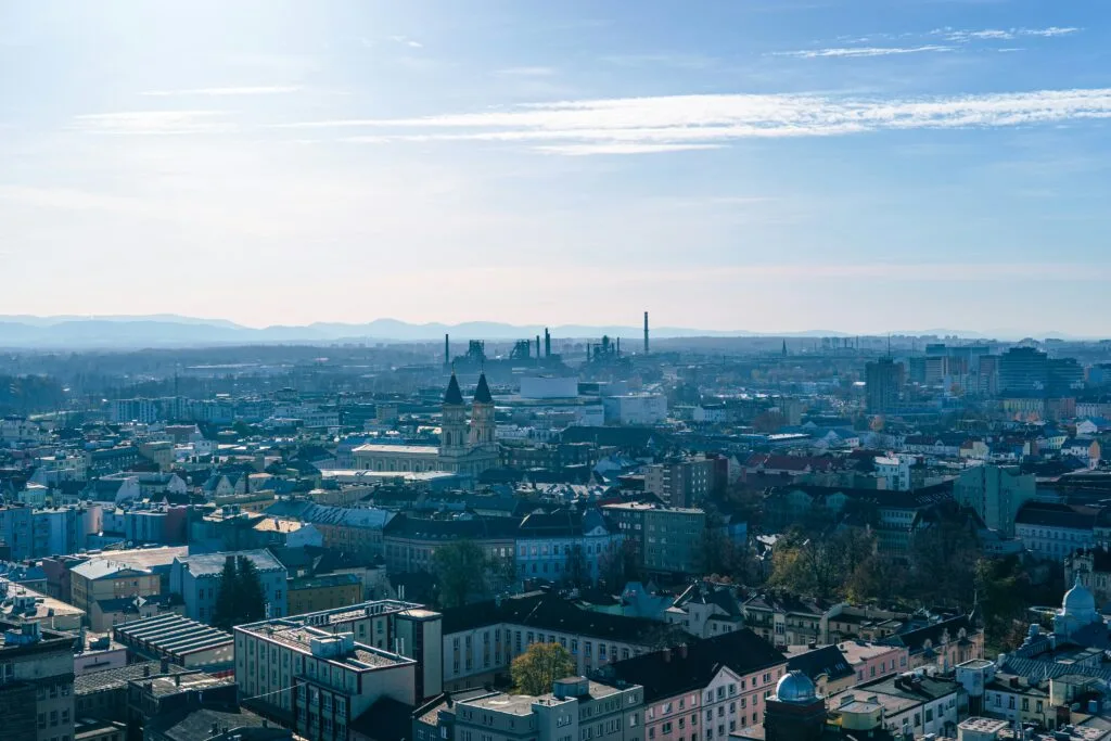 An aerial shot of Ostrava, with the steelworks of Dolní Vítkovice rising in the distance