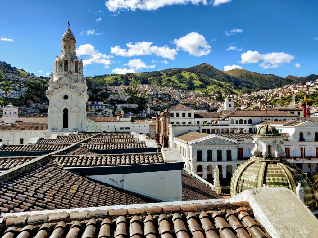 The churches and roofs of Quito stretch out to the mountains.
