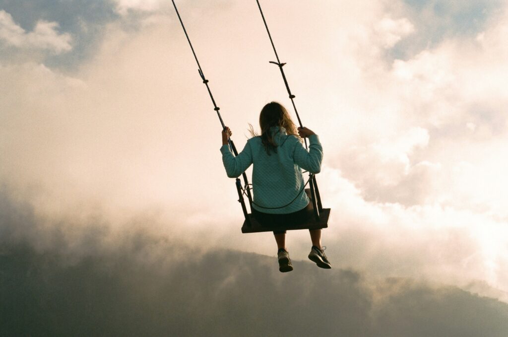 A woman swings into the clouds in the Casa Del Arbol in Baños, Ecuador.