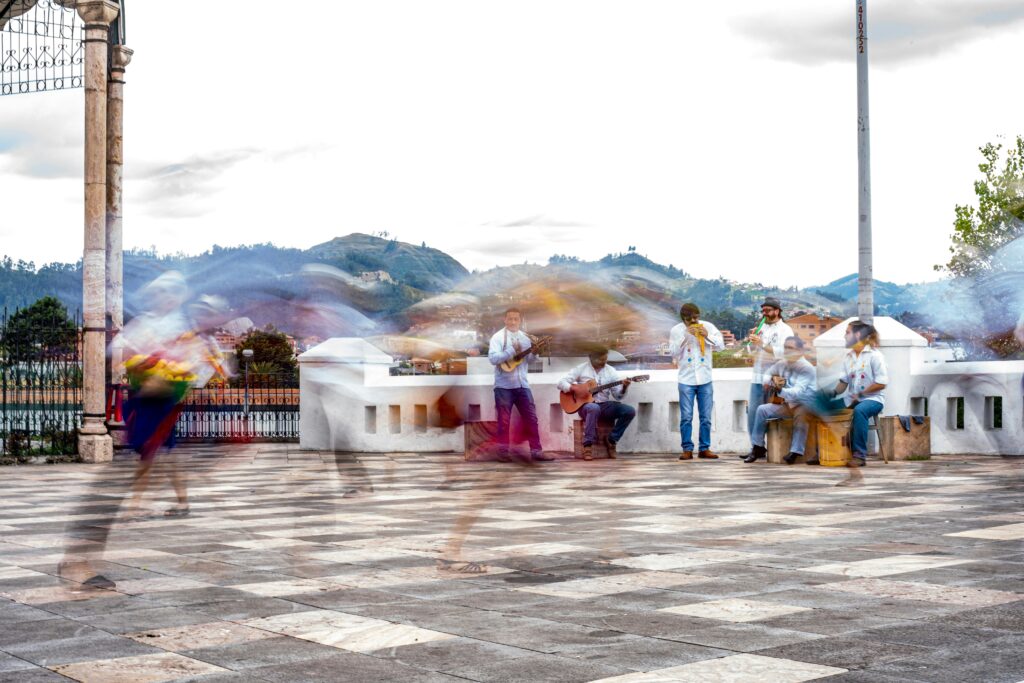 People dance as an indigenous band plays in Cuenca, Ecuador.