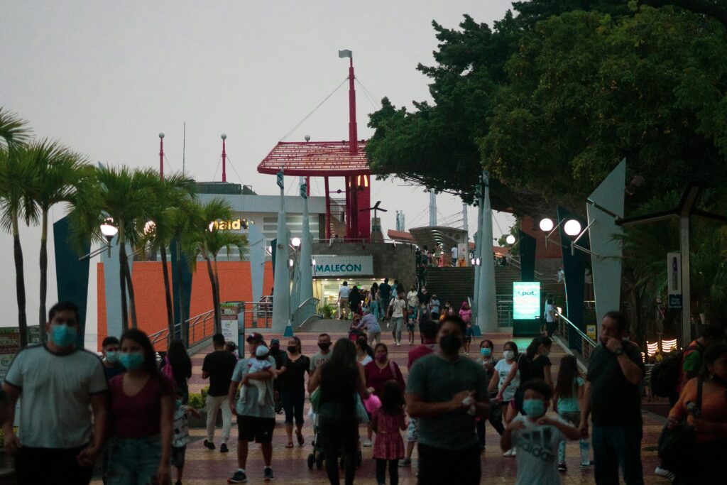 People walk along the Malecón 2000 at dusk in Ecuador. Wheely Tyred Guayaquil attractions