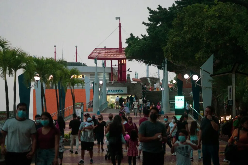 People walk along the Malecón 2000 at dusk in Guayaquil, Ecuador.