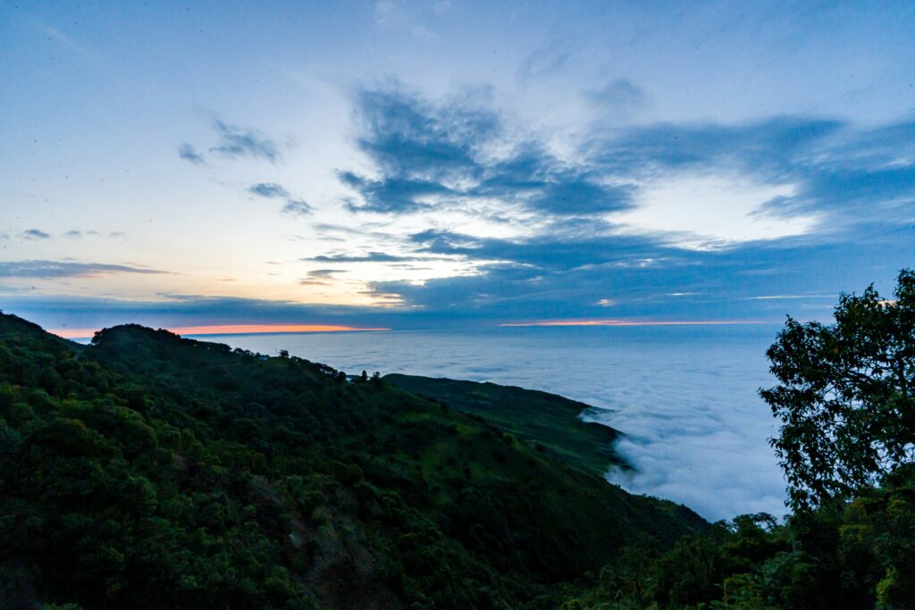 the mountains of the Ecuadorian Andes roll down towards Guayas at sunset. Wheely Tyred campsites near Guayaquil