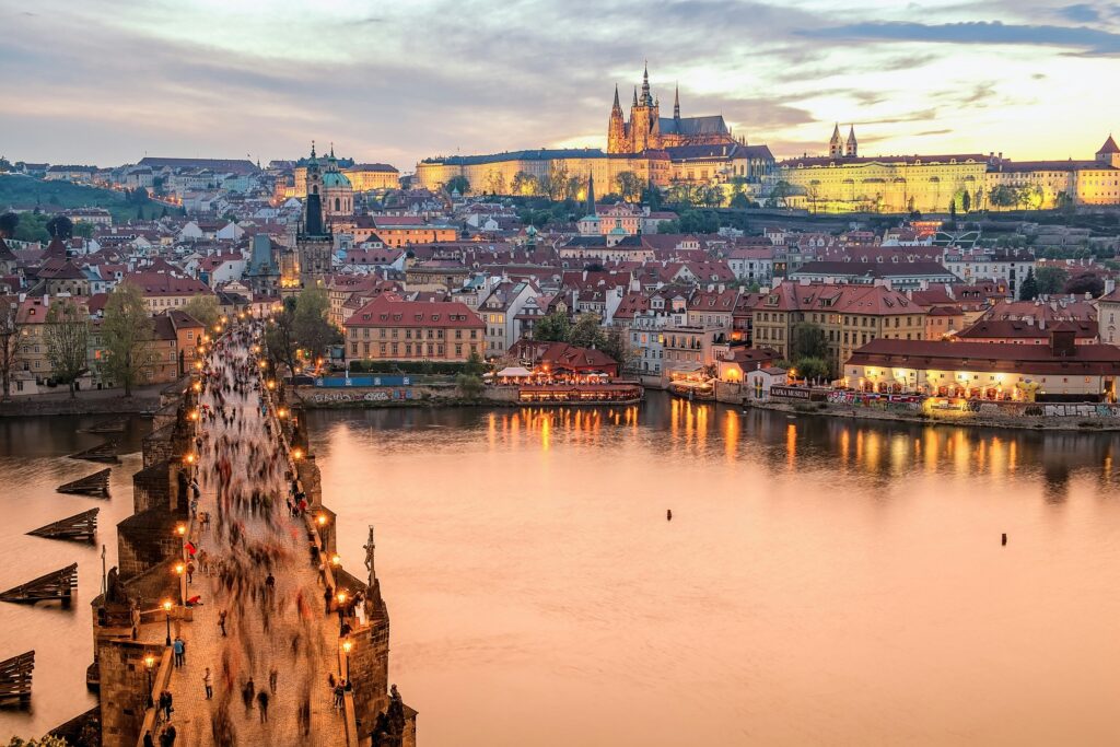 Thousands of people cross The Charles Bridge towards Prague Castle and the Cathedral of St Vitus.