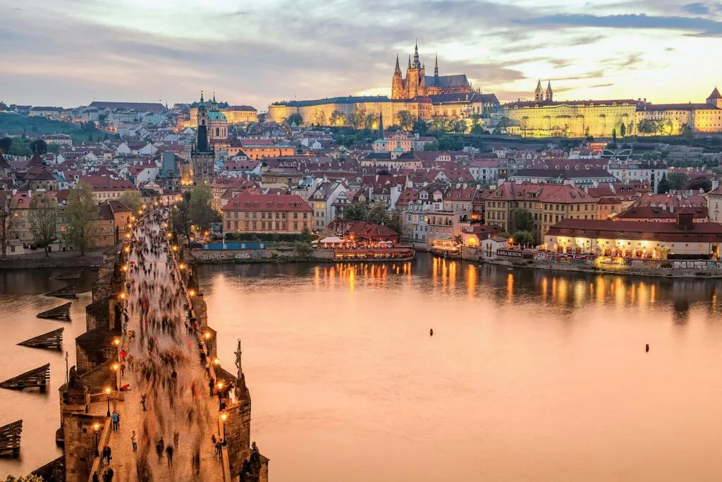 Thousands of people cross The Charles Bridge towards Prague Castle and the Cathedral of St Vitus.