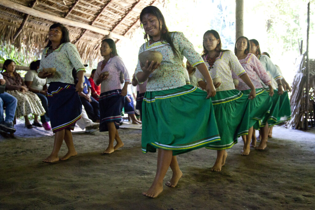 Women from the Kichwa Añangu community dance in a large hut in Yasuní, Ecuador.