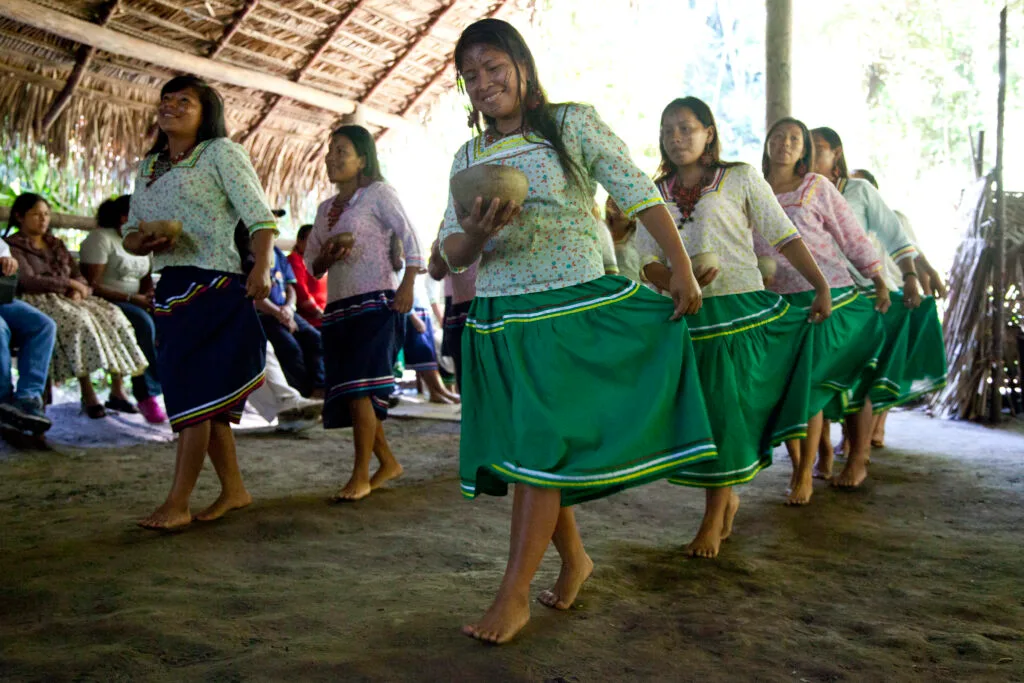 Women from the Kichwa Añangu community dance in a large hut in Yasuní, Ecuador.