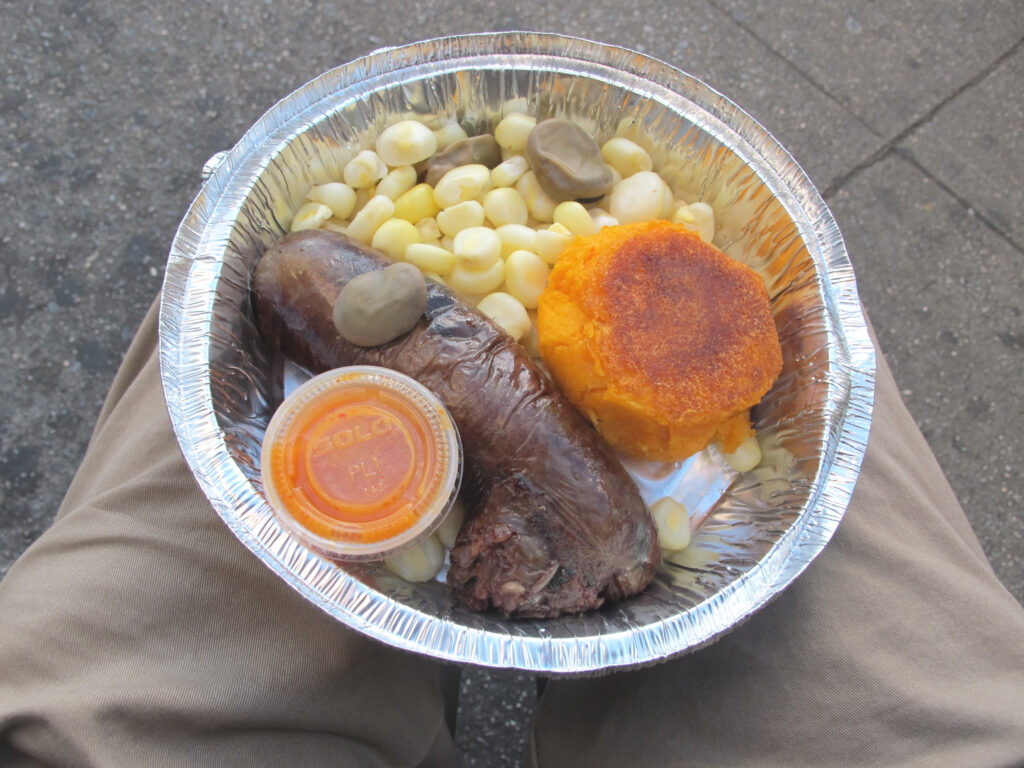 Morcilla, mote and llapingacho on a man’s knees in New York.