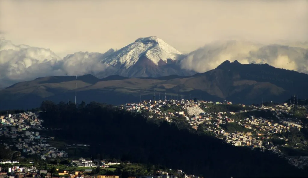 The snowcapped Volcán Cotopaxi rises through the clouds above Quito, Ecuador. Wheely Tyred What to eat in the Ecuadorian Sierra