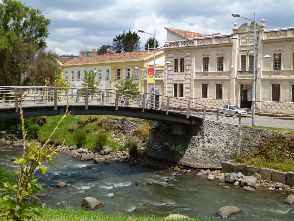 The Tomebamba River flows under a bridge in Cuenca, Ecuador.