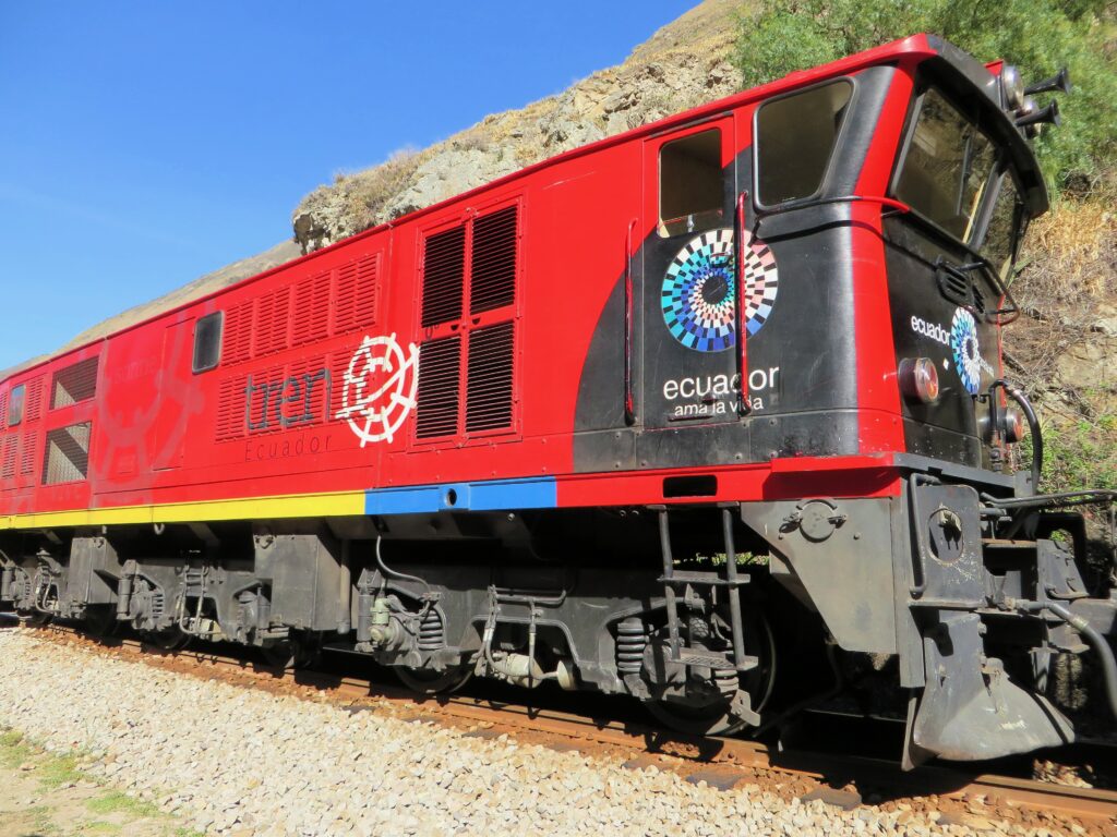 A large red train waits in Alausí, Ecuador