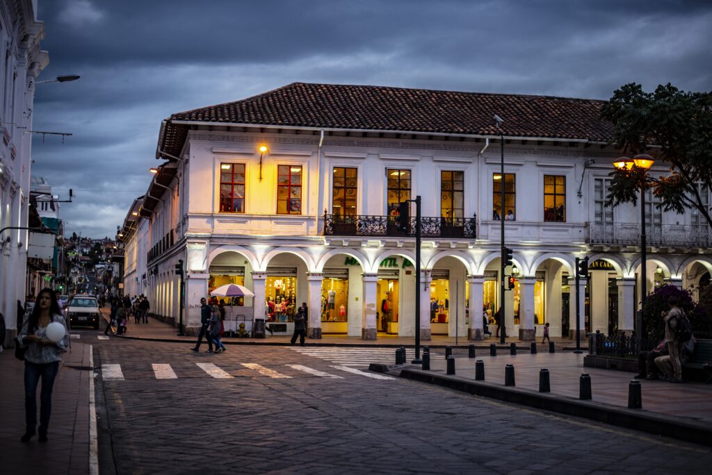 A large white building on the edge of Parque Calderon in Cuenca, Ecuador.